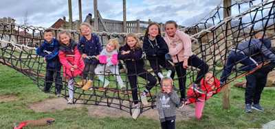Ten smiling children on a play net